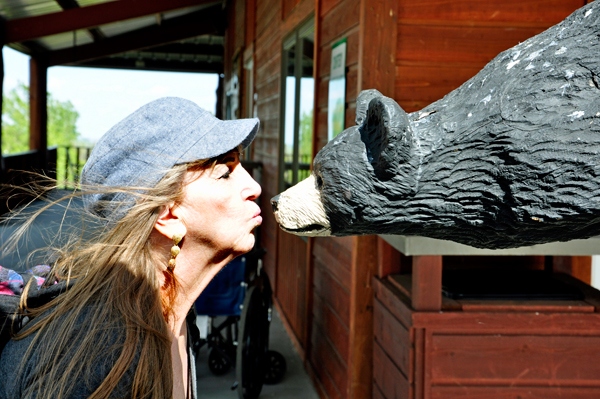Karen Duquette kissing a bear